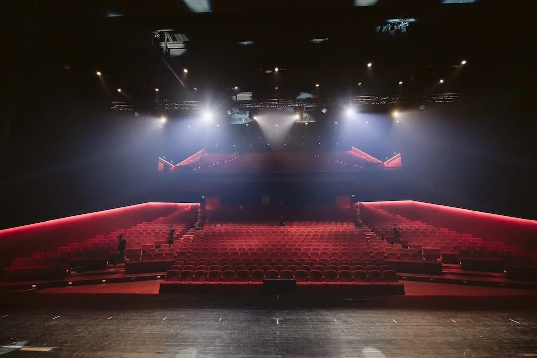 Empty red auditorium lit from the stage